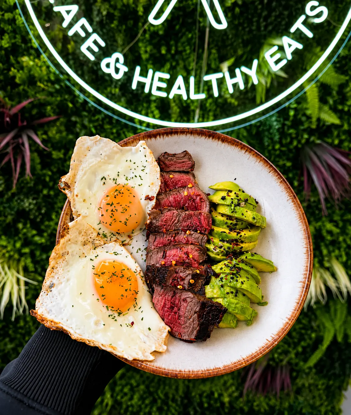 Steak skewers with fried eggs and greens